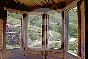 Looking thru a bay window in an old ghost town.