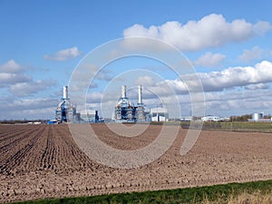 Looking to power plant and more over ploughed field