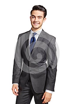 Looking towards a bright future. A handsome young businessman smiling at the camera against a white background.