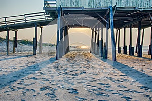 Looking under pier towards sandy beach at avon north carolina