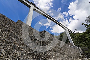 Looking up at Agas Agas bridge, the tallest bridge in the Philippines.Stone riprap abutment protects the foundation of the bridge