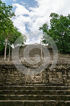 Looking up from ancient Mayan stone steps towards the sky in Calakmul, Mexico