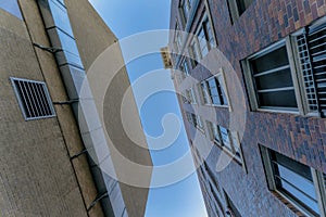 Looking up at apartments and blue sky from city streets in Austin Texas