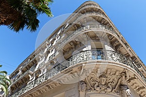 Looking up at the architectural details of an old apartment building in Toulon, France.