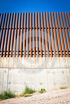 Looking up at border wall between united states and mexico