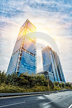 Looking up / Bottom view of modern skyscrapers in evening ligh