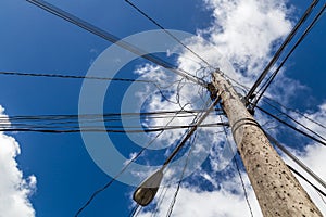 Looking up at a chaotic telegraph pole photo