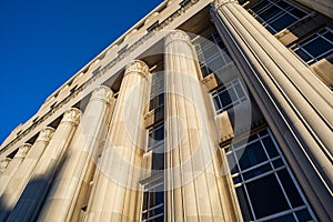 Looking up at Civil Courts building with stone Greek flutted columns and ornate design