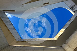 Looking up concrete building sky clouds