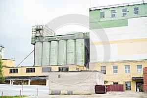 Looking up at a concrete or cement storage silo at an industrial flour mill