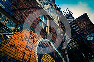 Looking up at graffiti and old staircases in Graffiti Alley, Baltimore, Maryland. photo