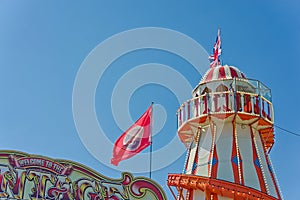 Looking up at a helter skelter ride with blue sky in background