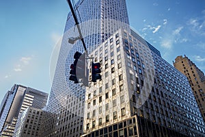 Looking up at Manhattan intersection wit h straffic lights at 42nd street and 3rd ave business buildings and skyscrapers