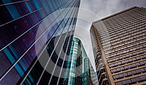 Looking up at modern buildings under a cloudy sky in Philadelphia, Pennsylvania.