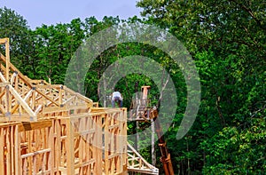 Looking up new construction beams under a clear blue sky with sunlight