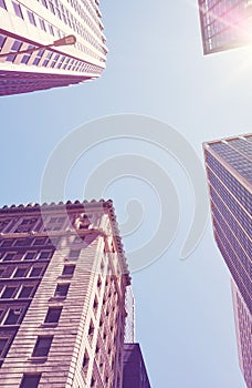 Looking up at New York buildings against the sun, color toned picture, USA