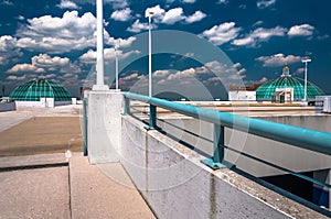 Looking up a parking garage ramp, under a blue summer sky in Tow