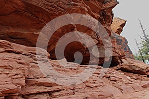 Looking up at a red sandstone cave in the mountains of Sedona, Arizona