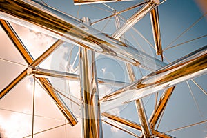 Looking up at the sky through an abstract chrome statue at the Frederik Meijer Gardens