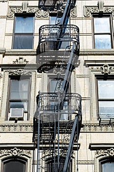 Small Black Fire Escapes on an Old White Stone Building on the Lower East Side of New York City