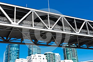 Looking up at the span section of San Francisco - Oakland Bay Bridge on a sunny day with blue sky.