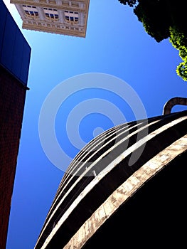 Looking Up at Spiral Parking Garage Ramp and Building and Tree