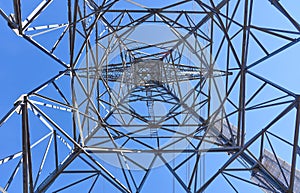 Looking up into the structure of an electrical transmission tower