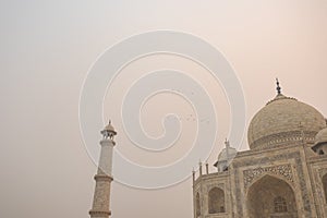 Looking up at the Taj Mahal in Agra, India, on overcast morning with smog