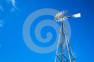 Looking Up at Tall Metal Water Pumping Windmill