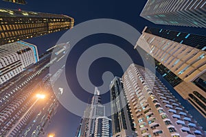 Looking up to high-rise office buildings, skyscrapers, architectures in financial district. Smart urban city for business and