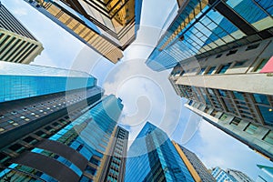 Looking up to high-rise office buildings, skyscrapers, architectures in financial district. Smart urban city for business and