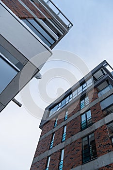 Looking up to modern new brown brick apartment buildings at Pille street during winter time. Tallinn, Estonia, Europe