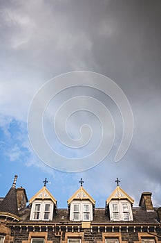 Looking up to the rooftop windows of a typical old building in t