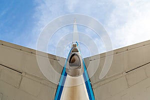 Looking up to the tail and stabiliser of a blue aircraft