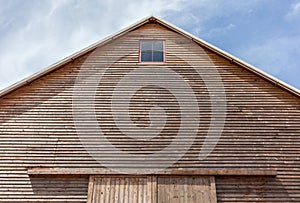 Looking up the top of gabled roof on a wooden barn