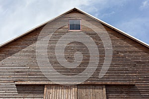 Looking up at the top of a gabled roof on a wooden barn