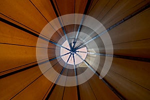 Looking up towards teepee-ceiling from inside the tent shows bright day light filtering in creating a cozy ambience photo