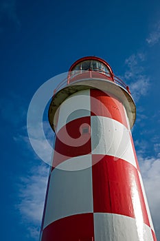 Looking up at Towering Red and White Lighthouse