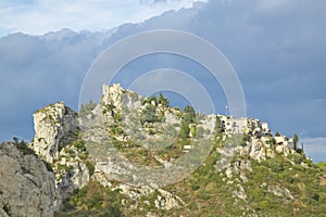 Looking up at Town of La Turbie with Trophee des Alpes and church, France