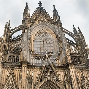 Looking at the upper section of majestic Cologne Cathedral, set against an overcast sky