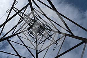 looking upward center high voltage mast sky