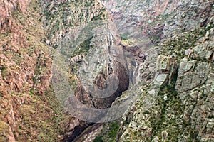 Looking way down at the Arkansas River and train running beside it in the Royal Gorge in Colorado