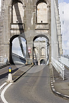 Looking westwards through the stone arches of the Menai Suspension Bridge, Gwynedd, North Wales