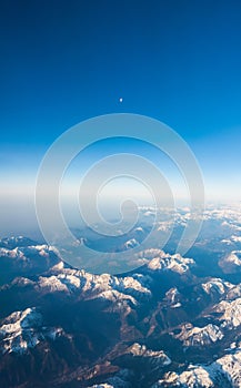 Looking through the window aircraft during flight a snow covered Italian and Osterreich