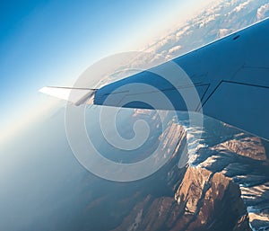 Looking through the window aircraft during flight a snow covered Italian and Osterreich