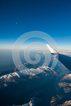 Looking through the window aircraft during flight a snow covered Italian and Osterreich