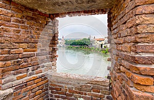 Looking through a window at Castelvecchio bridge or Scaligero bridge in Verona, Italy. It is one of the symbols of the city.