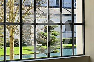 Looking through window to garden of monastery