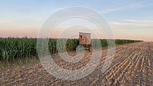 Lookout tower between corn field and empty field