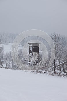 A lookout tower or mirador for wooden hunting in the mountains in the snow